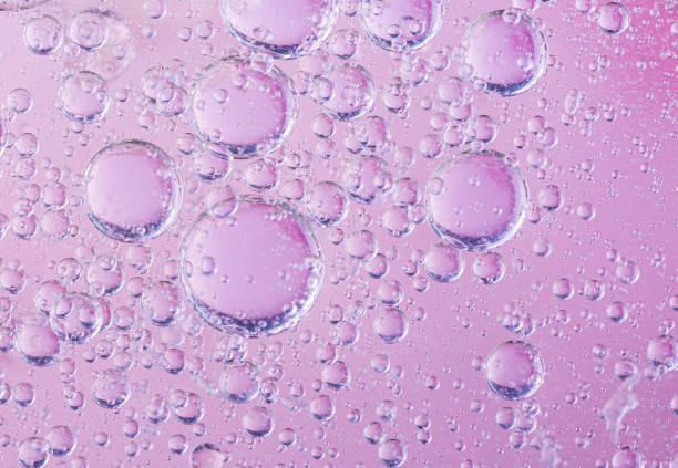 oil with bubbles on coral background. Pink Abstract space background. Soft selective focus. macro of oil drops on water surface. copy space. air bubbles in water