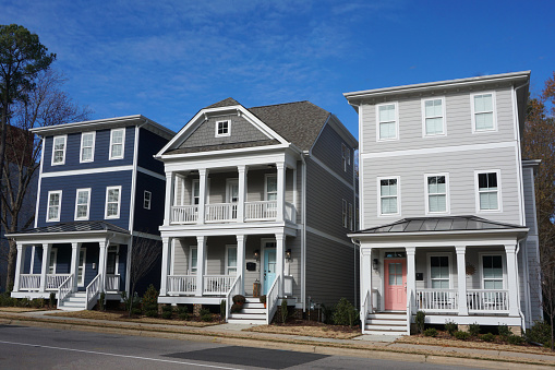 Exterior view in a suburban neighborhood in North Carolina. Three, multi-story town homes