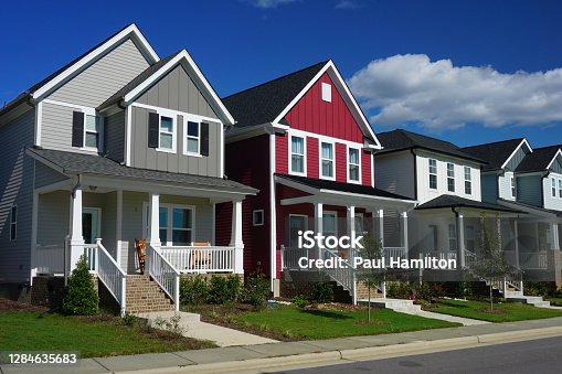 istock Red and Gray Row Houses in Suburbia 1284635683