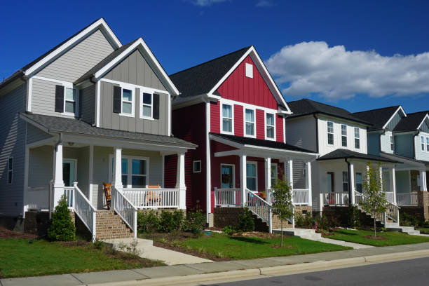 Red and Gray Row Houses in Suburbia Street view of a row of houses. The front of each house has a porch, stairs and a sidewalk. home stock pictures, royalty-free photos & images
