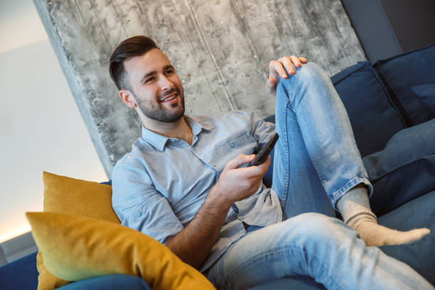 istock Bachelor man daily routine in the living room single lifestyle concept watching program joy 1284635865