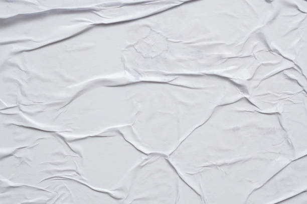 istock Blank white crumpled and creased paper poster texture background 1284636050