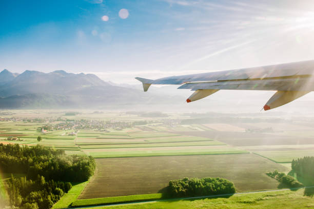 istock airplane flying over land in the sun 1284649522
