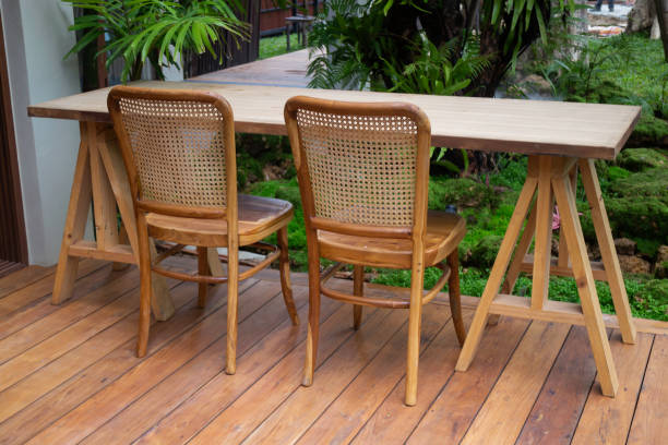 istock Wooden table and chairs in tropical garden 1284651081