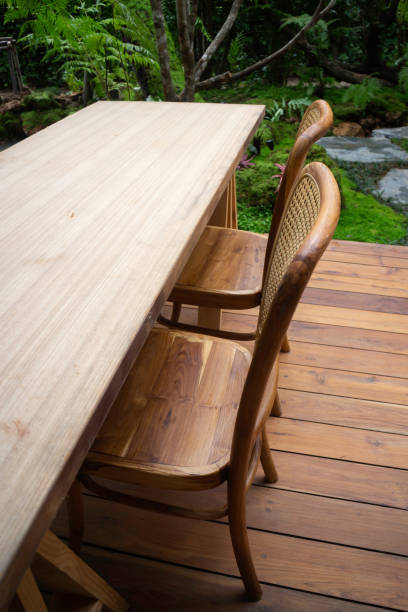 istock Wooden table and chairs in tropical garden 1284651092