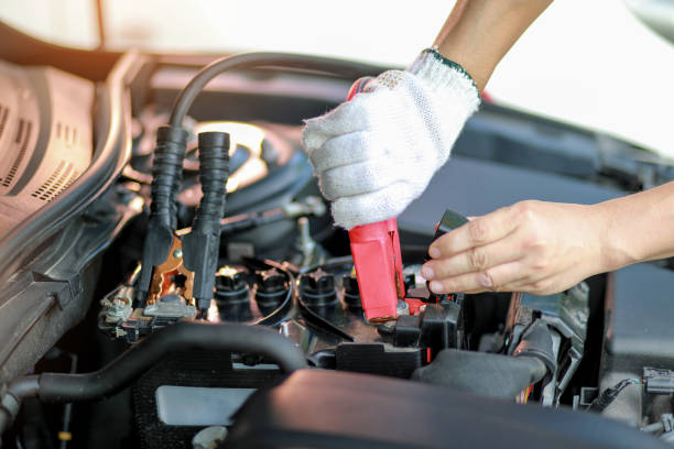 Close up Charging car battery with electricity trough jumper cables. Car repair concept. Close up Charging car battery with electricity trough jumper cables. Car repair concept. car battery stock pictures, royalty-free photos & images