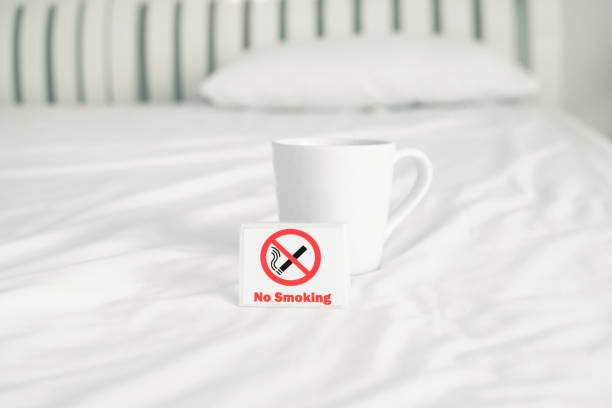 istock no smoking sign and white ceramic coffee cup on white bed in the morning 1284652902