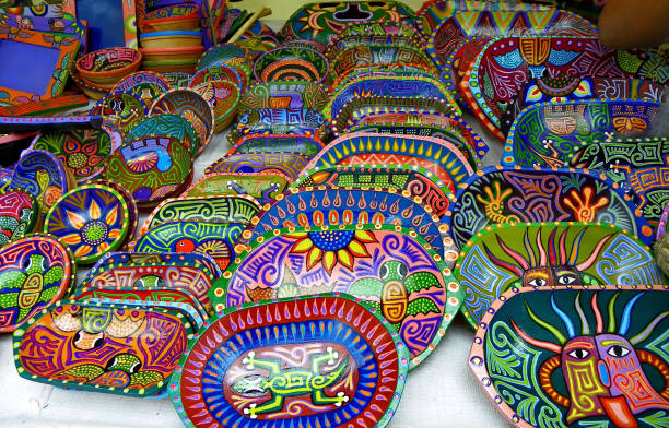 Souvenirs plates made of wood from Cotopaxi, Ecuador Andean Indigenous Culture of Tigua, Cotopaxi. Souvenirs plates made of wood, painted with striking colors acrylics. They portray animals, folklore characters cotopaxi photos stock pictures, royalty-free photos & images