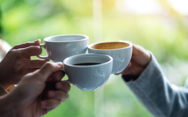 A group of young people enjoyed drinking and clinking coffee cups together
