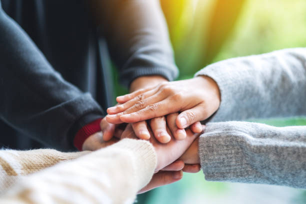 istock business team standing and joining their hands together in office 1284656299