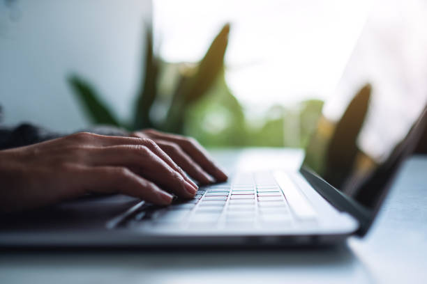 istock a woman working and typing on laptop computer keyboard on the table 1284656303