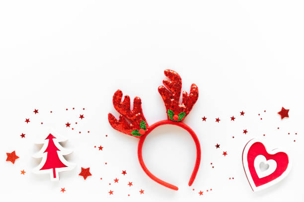 istock Christmas art composition with red decorations, reindeer headband on white surface. Christmas celebration concept. Flat lay, copy space, greeting card 1284658981