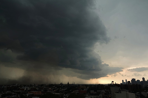 Thunderstorm over meadows and large cumulonimbus thundercloud and rain