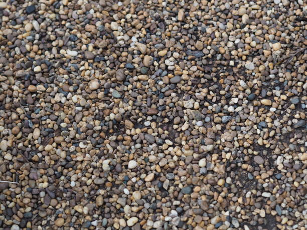 istock Abstract background with pebbles small round sea stones Beach rocks Texture material nature 1284670614