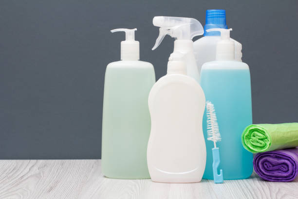 istock Bottles of detergent and garbage bags on gray background. 1284671274