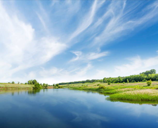 istock Landscape with fields, pond, hills and scenic sky 1284676647