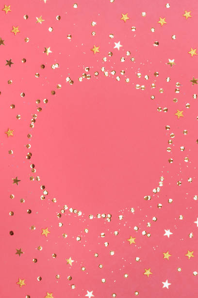 istock Pink background with glitter and golden stars. Sparkling texture. Festive backdrop for your projects 1284676875