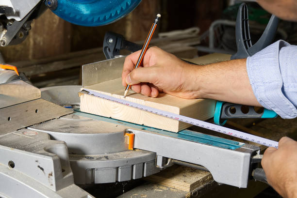 istock Carpenter work with circular saw for cutting wood bar, the man sawed bars, construction and home renovation. Carpenter work concept 1284677802