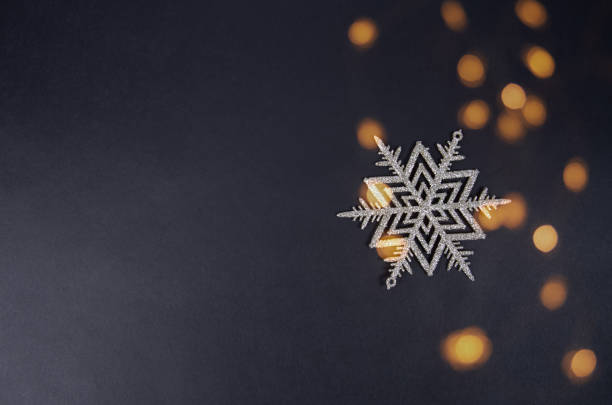 istock Christmas toy snowflake on a black background and free space for text 1284679686