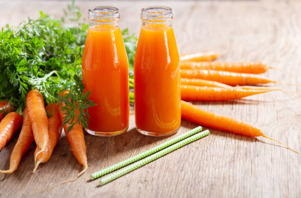 istock bottles of fresh carrot juice 1284680246