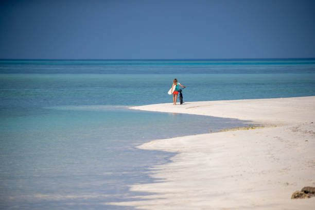 istock Surfer walks a bike on the beach 1284680358