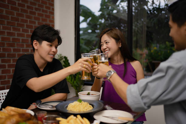 istock Young asian group are drinking beer and the clink glasses in a restaurant. 1284680933