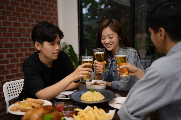 istock Group of young Asians drinking beer in a restaurant at night. 1284681375