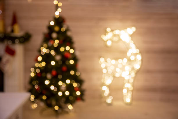 istock defocused background christmas celebration tree and deer garland at home. 1284682453