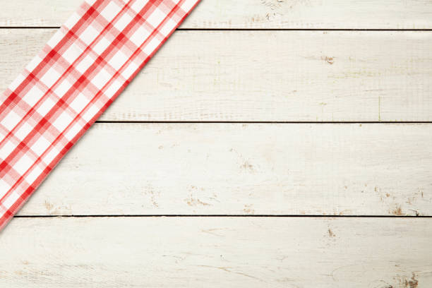 istock Red and white fabric with decoration on white grunge wooden background. 1284682502
