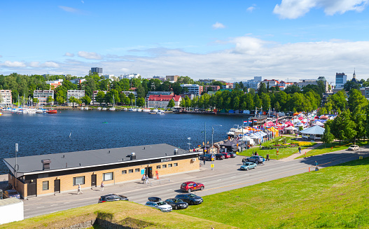 Lappeenranta , Finland - July 1, 2017: Lappeenranta harbor view at sunny summer day, ordinary people walk the coastal road