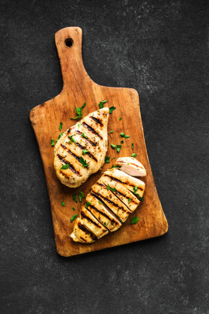 Grilled chicken breast Grilled chicken breast, fillet, steak on wooden board, top view, copy space. Healthy keto, ketogenic meal, homemade bbq chicken meat ready to eat. grilled chicken breast stock pictures, royalty-free photos & images