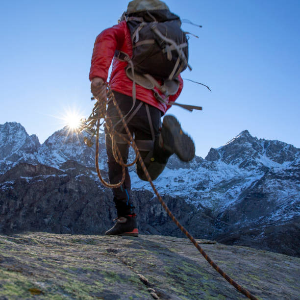 istock Mountaineer ascends mountain ridge crest 1284687296