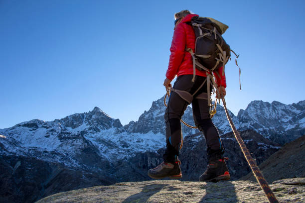 istock Mountaineer ascends mountain ridge crest 1284687301