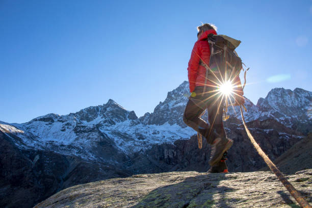 istock Mountaineer ascends mountain ridge crest 1284687328