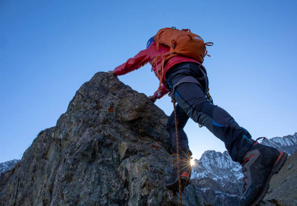 istock Mountaineer ascends mountain ridge crest 1284687348