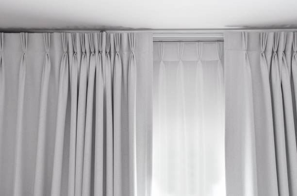 istock Two layers curtain with rails, installed on ceiling, translucent and blocking lights curtain 1284687380