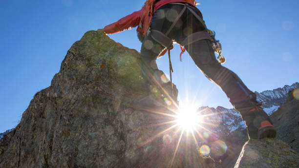 istock Mountaineer ascends mountain ridge crest 1284687423