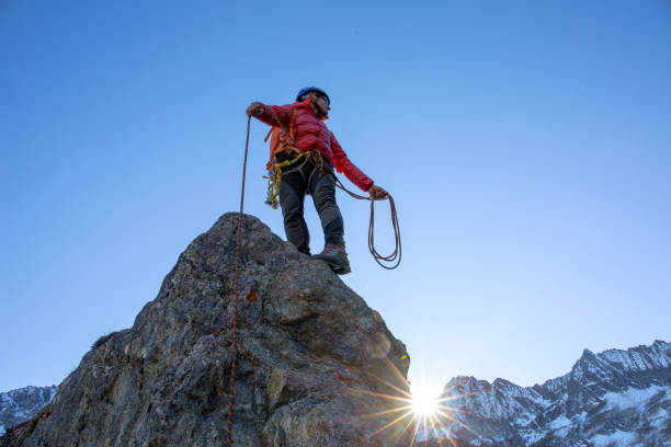 istock Mountaineer ascends mountain ridge crest 1284688310