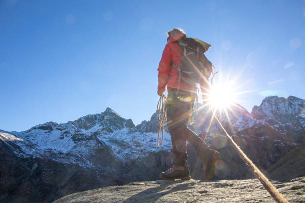 istock Mountaineer ascends mountain ridge crest 1284688328