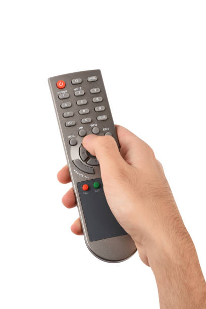 istock Men's hand holding TV remote control, men's finger pushing TV remote control button on the white background (Clipping Path) 1284689062