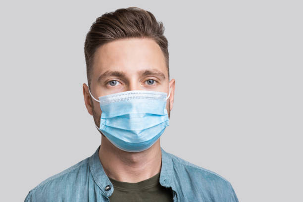istock Portrait of a young man wearing protective face mask 1284690507