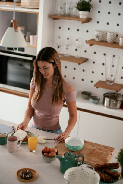istock Beautiful woman preparing breakfast and drinking juice. 1284690769