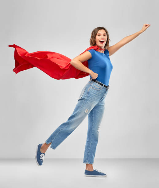 istock happy woman in red superhero cape 1284692027