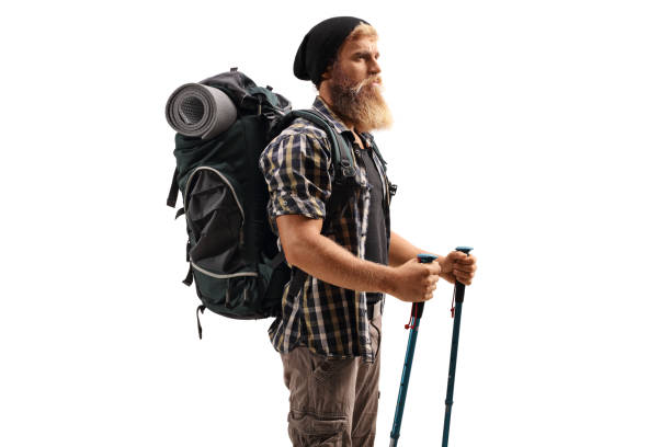 istock Young bearded man with a backpack and hiking poles 1284692114