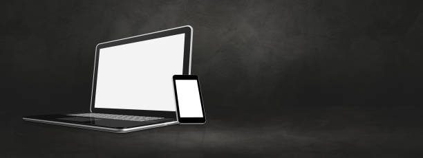 istock Laptop and mobile phone on dark concrete office scene banner 1284693202