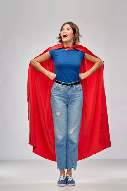 istock happy woman in red superhero cape 1284693337