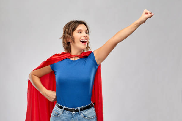 istock happy woman in red superhero cape 1284693381