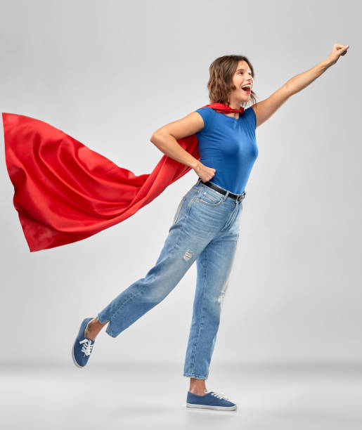 istock happy woman in red superhero cape 1284694441