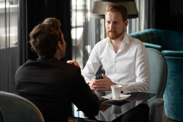 istock Handsome two businessmen have a meeting in cafe 1284694593
