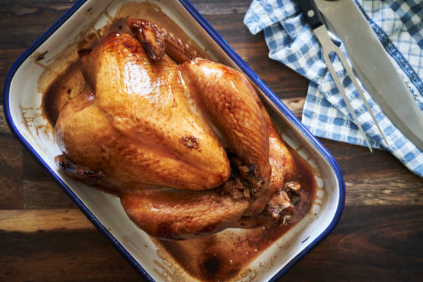 istock Preparing Stuffed Turkey for Holidays in Domestic Kitchen 1284694834